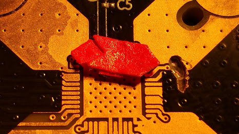a close up of a motherboard with a red object on it